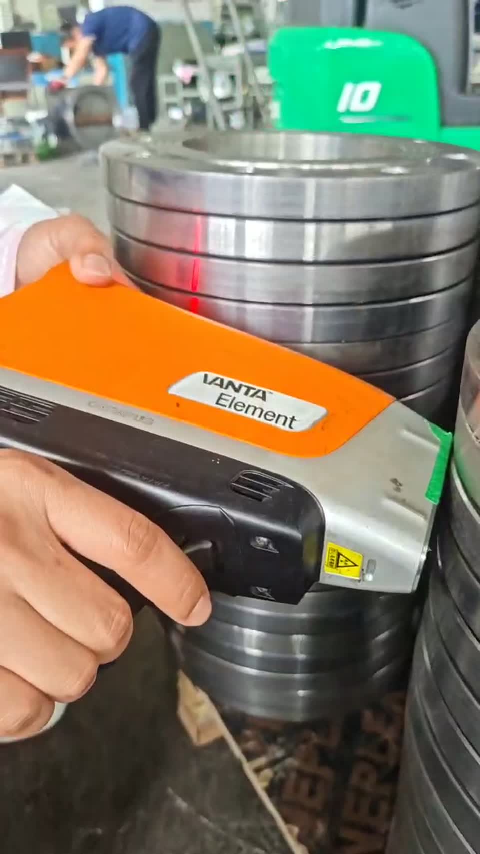 Handheld analyzer being used for positive material identification